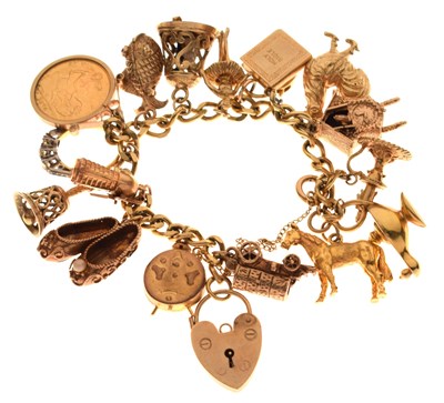 Lot 75 - 9ct gold curb link bracelet attached various charms, etc