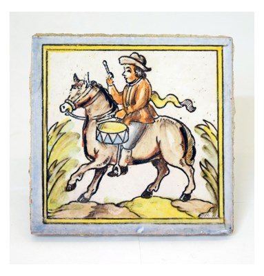 Lot 330 - Continental tile depicting a drummer on horseback