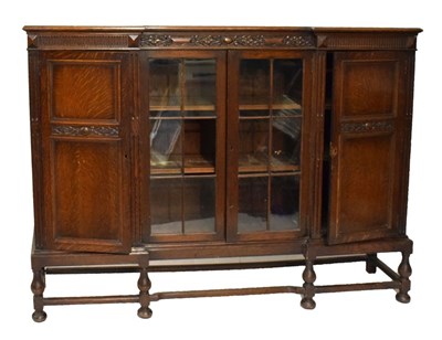 Lot 590 - Large oak bookcase on stand, (one pane of glass missing)