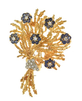 Lot 22 - Diamond and sapphire 18ct yellow and white gold set floral spray brooch