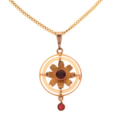 Lot 55 - Pendant depicting a flower with two faceted red stones
