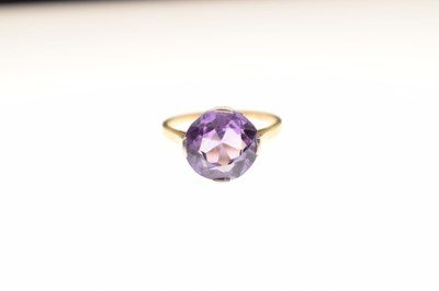 Lot 16 - Unmarked yellow metal ring set purple stone