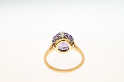 Lot 16 - Unmarked yellow metal ring set purple stone