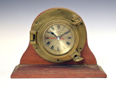 Lot 518 - Ships Time clock in a porthole style mount