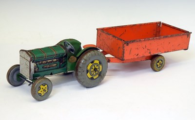 Lot 247 - Mettoy Playthings tinplate clockwork tractor with red trailer