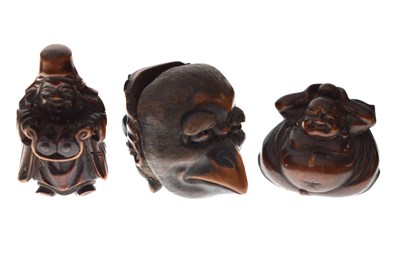 Lot 257 - Two Japanese carved boxwood netsuke and a carved nut in the form of two faces