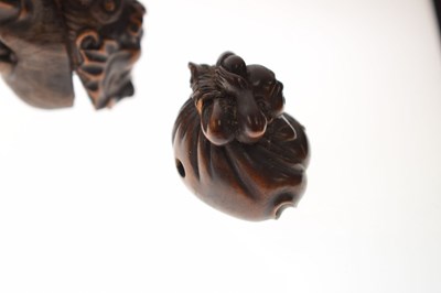 Lot 257 - Two Japanese carved boxwood netsuke and a carved nut in the form of two faces
