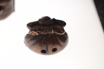 Lot 257 - Two Japanese carved boxwood netsuke and a carved nut in the form of two faces