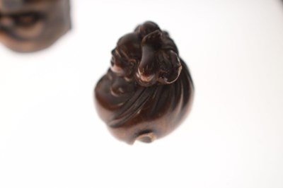 Lot 257 - Two Japanese carved boxwood netsuke and a carved nut in the form of two faces