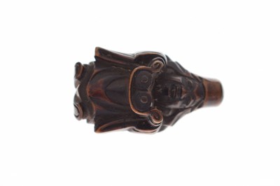 Lot 257 - Two Japanese carved boxwood netsuke and a carved nut in the form of two faces