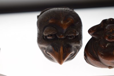 Lot 257 - Two Japanese carved boxwood netsuke and a carved nut in the form of two faces