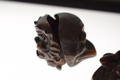 Lot 257 - Two Japanese carved boxwood netsuke and a carved nut in the form of two faces