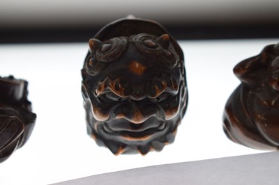 Lot 257 - Two Japanese carved boxwood netsuke and a carved nut in the form of two faces