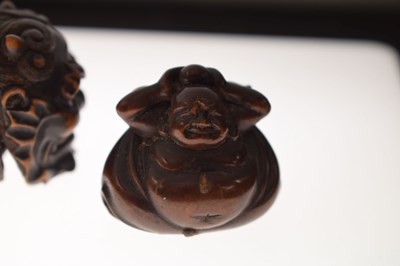 Lot 257 - Two Japanese carved boxwood netsuke and a carved nut in the form of two faces