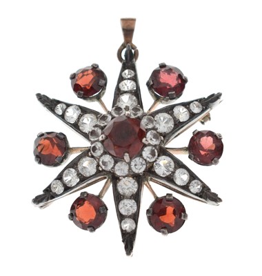 Lot 28 - Victorian garnet and white stone pendant brooch, starburst