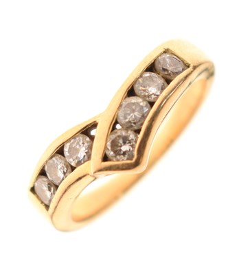 Lot 1 - Unmarked yellow metal seven-stone diamond ring