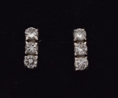 Lot 85 - Pair of platinum and three-stone diamond ear studs