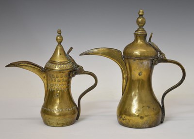 Lot 477 - Two Turkish / Middle Eastern Islamic brass dallah coffee pots