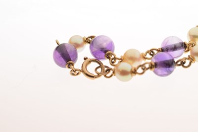 Lot 30 - '9ct' yellow metal seed pearl and purple stone set bar brooch