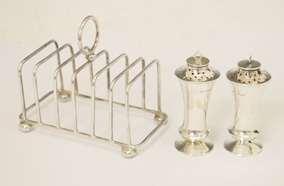 Lot 163 - Pair of George V silver pepperettes, and silver toast rack