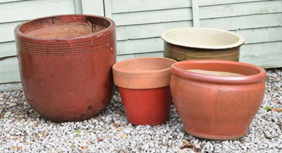 Lot 714 - Three red glazed terracotta garden planters and a brown glazed example