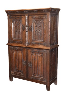 Lot 693 - Early 20th century oak gothic revival two section cupboard