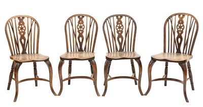 Lot 679 - Four early 20th century elm and fruitwood wheel-back Windsor chairs