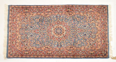 Lot 572 - Middle Eastern blue and red ground wool rug