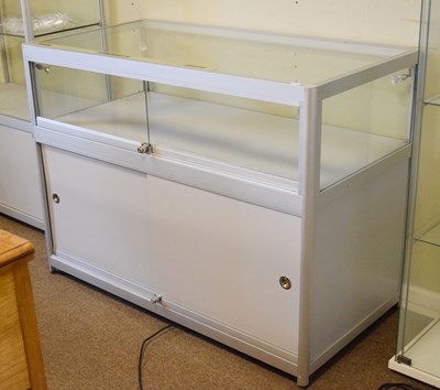 Lot 642 - Modern glazed panelled and metal framed shop display low cabinet