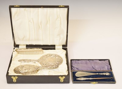 Lot 197 - Cased Elizabeth II silver-backed dressing table set, and a silver handled shoe horn and button hook