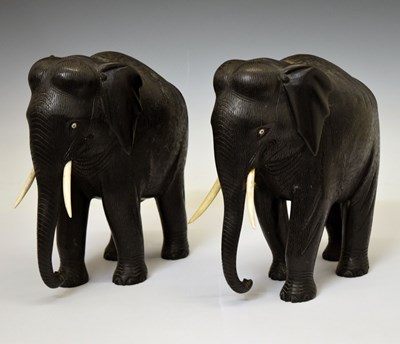 Lot 526 - Pair of ebony elephants with ivory tusks