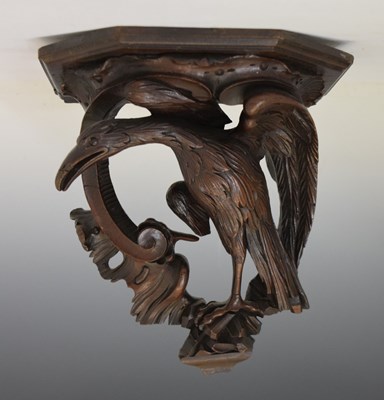 Lot 394 - Carved wood wall bracket depicting a perched stylised bird