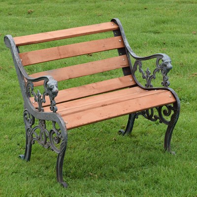 Lot 734 - Garden seat having scroll decorated ends with metal lion heads