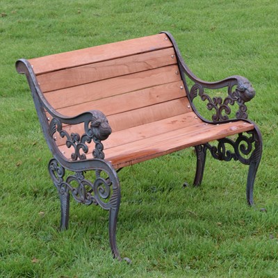 Lot 733 - Garden seat having scroll decorated ends with metal lion heads