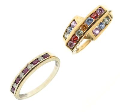 Lot 60 - Ruby and diamond channel set 9ct gold half eternity ring