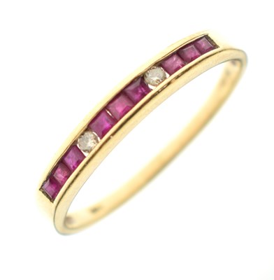 Lot 35 - Ruby and diamond 18ct gold channel set ring