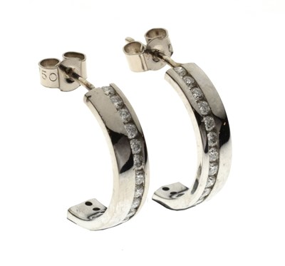 Lot 184 - Pair of diamond set 18ct white gold half hoop earrings