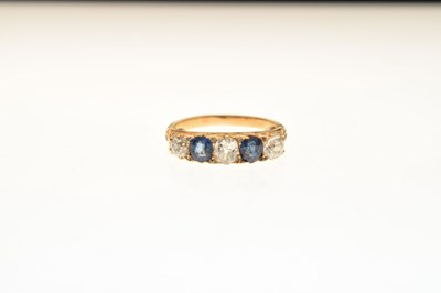 Lot 38 - Five-stone diamond and sapphire ring