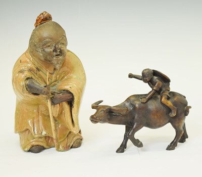 Lot 586 - Japanese pottery figure of a gentleman and a resin figure of a boy on buffalo