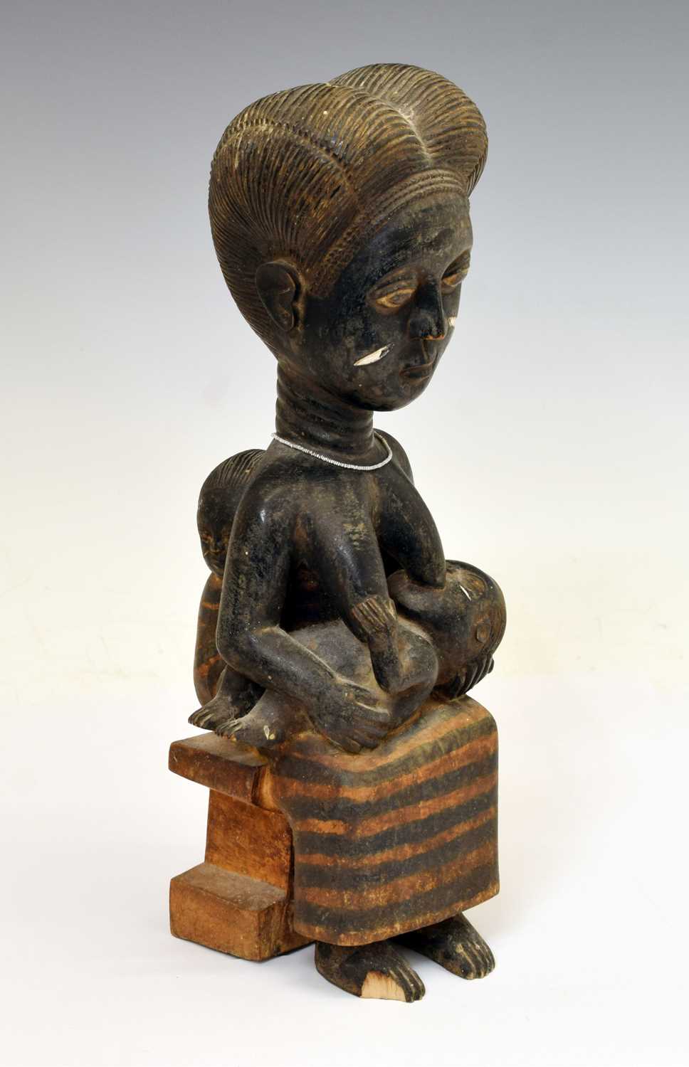Lot Ethnographica - African carved wooden fertility figure, mother and two children