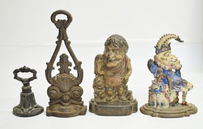 Lot 730 - Two early 20th century cast iron Mr Punch doorstops and two other