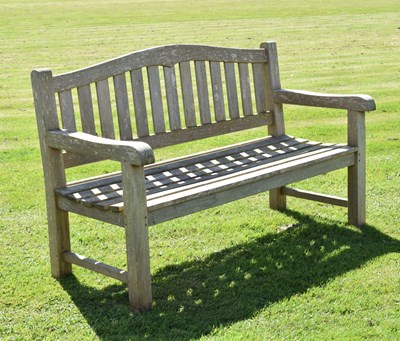 Lot 787 - Two person teak garden bench with arched back