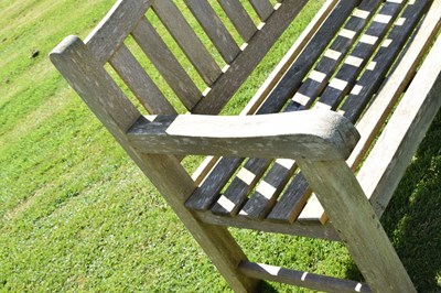 Lot 787 - Two person teak garden bench with arched back