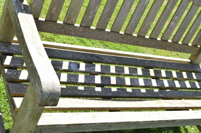 Lot 787 - Two person teak garden bench with arched back