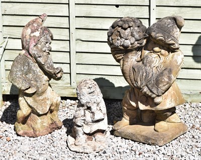 Lot 814 - Group of three composition stone garden ornaments of gnomes