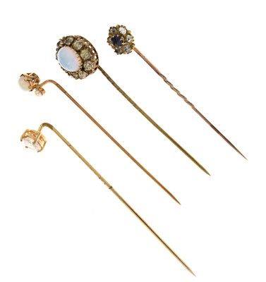 Lot 122 - Four gem-set stick pins