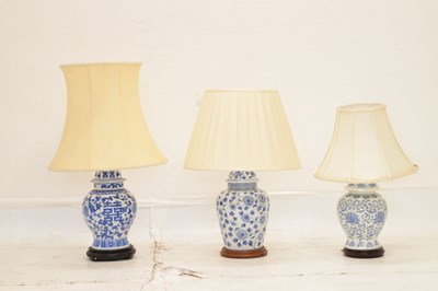 Lot 426 - Three modern Chinese blue and white table lamps