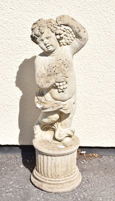 Lot 795 - Composite stone garden statue of a cherub holding grapes