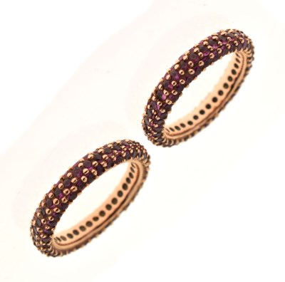 Lot 59 - Pair of ruby pave set eternity rings