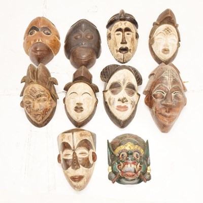 Lot 446 - Group of ten carved wall hanging masks